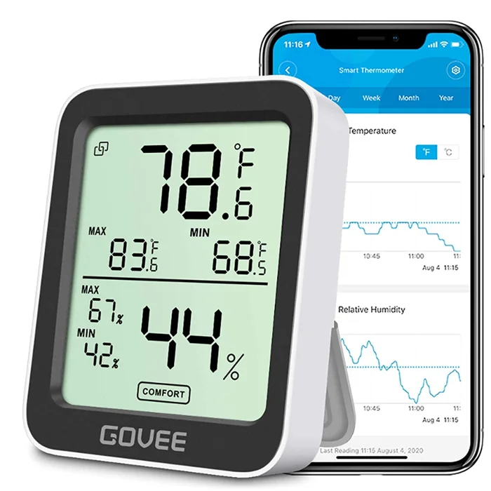 Govee H5075 indoor hygrometer thermometer beside a phone showing its temperature and humidity graphs